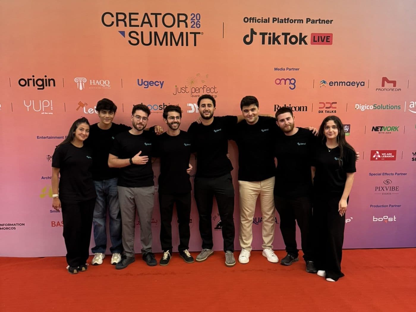 The Blend team in black Blend shirts on the red carpet in front of the Creator Summit 2026 sponsor wall
