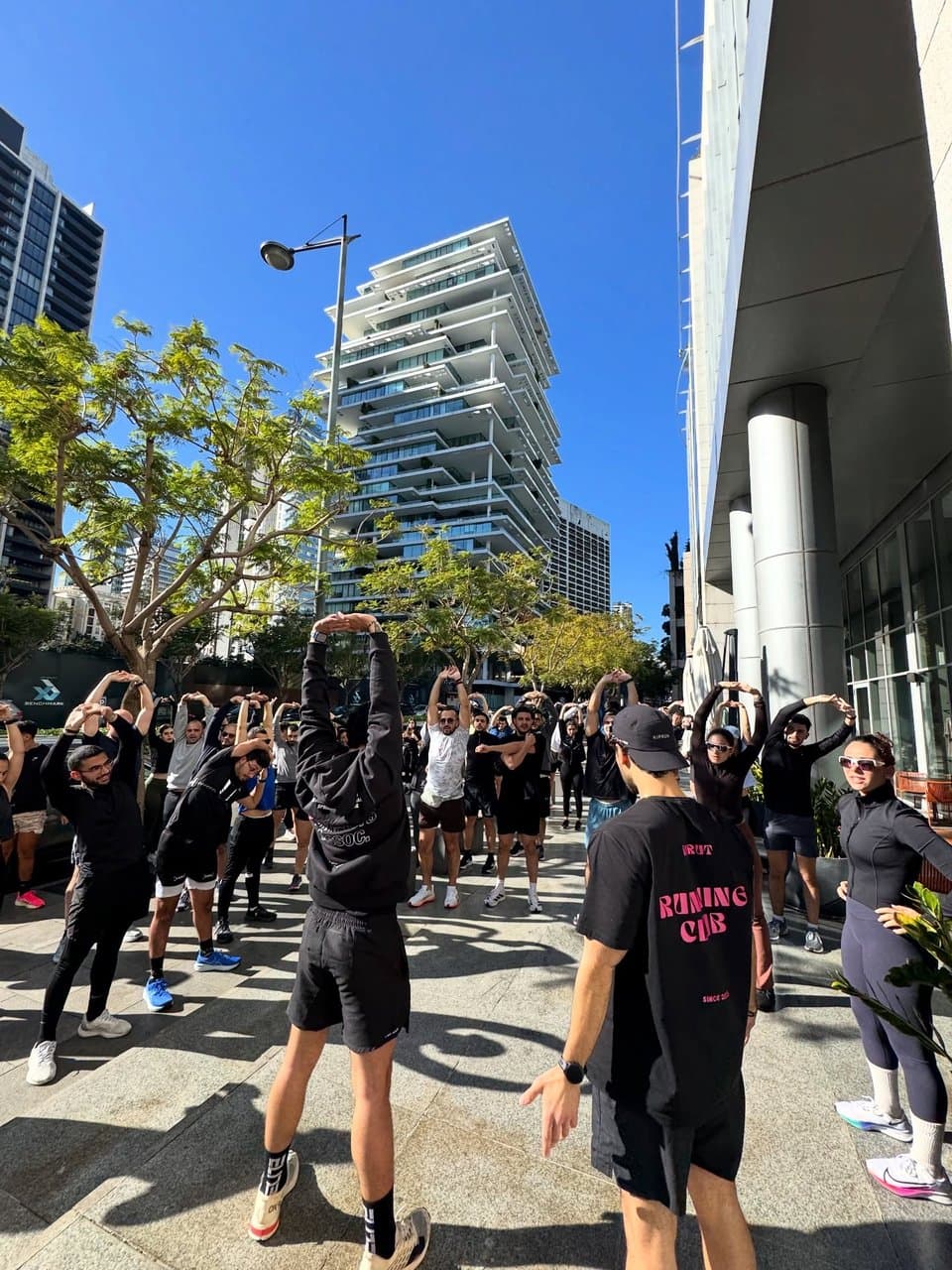 A group warm-up before a run on a Beirut street, with one runner's shirt reading 'Beirut Running Club, since 2017'