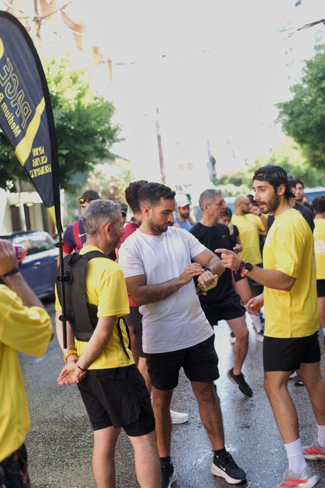 Runners gathered at the start with a Run Club Beirut flag and banner in the foreground