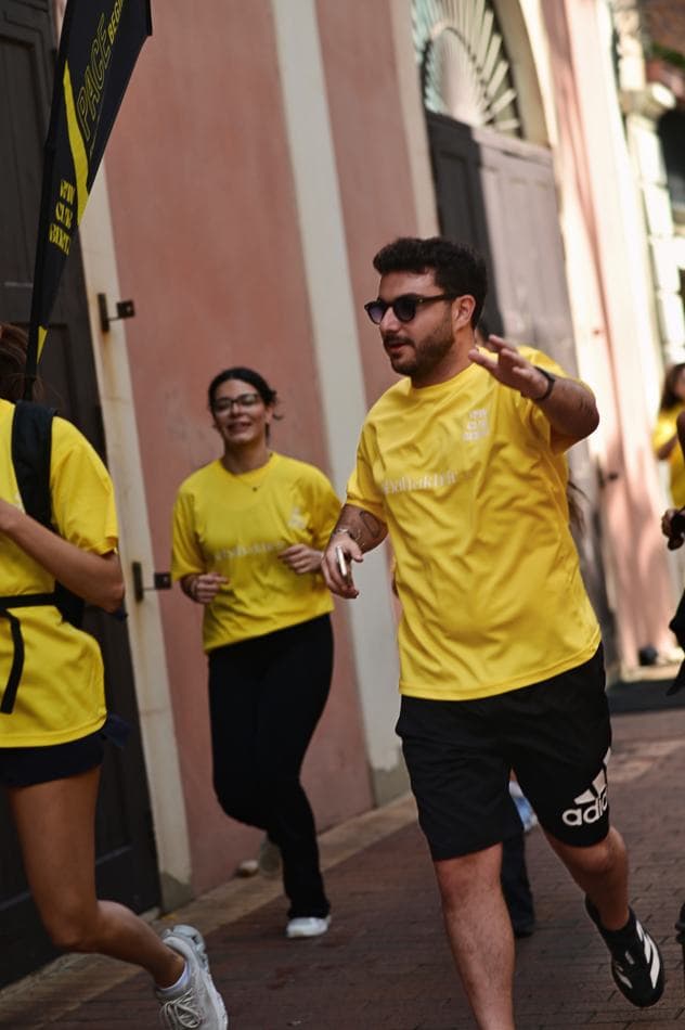 Two runners in Sabah El Kheir Run t-shirts jogging together and smiling