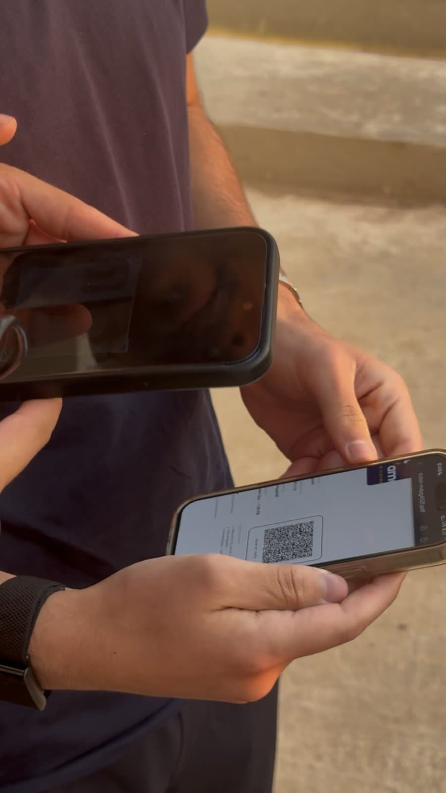 A member of Taht El Amar's team scanning a guest's QR ticket on a phone at the door