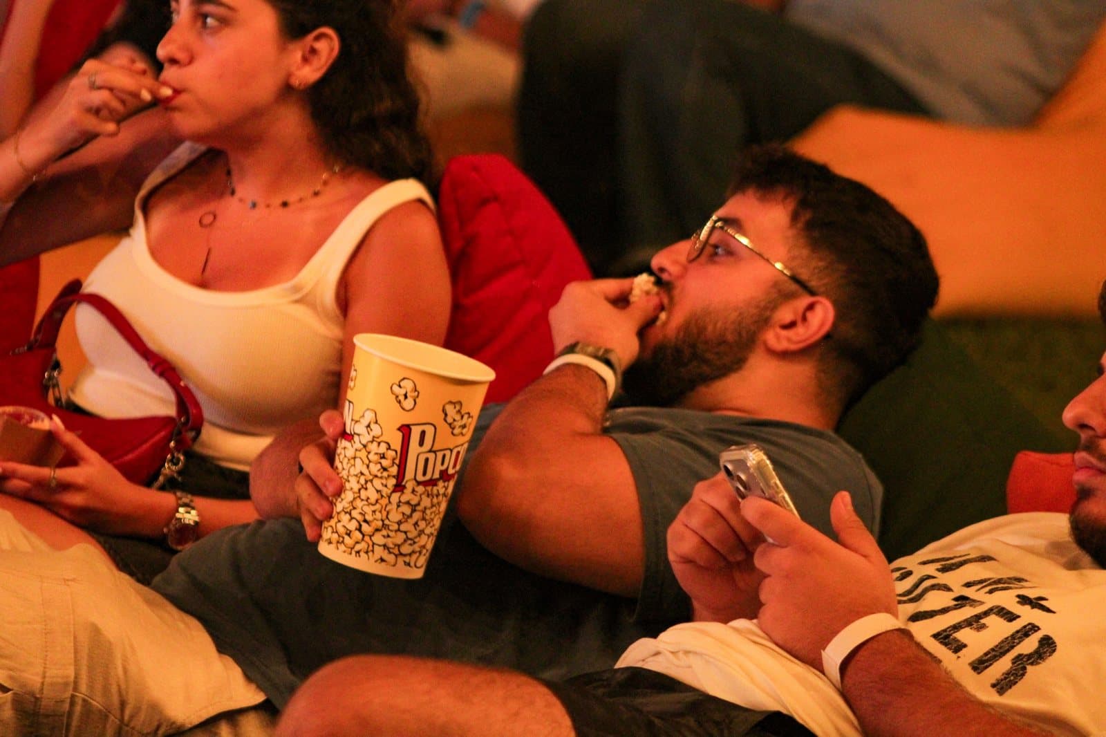 A couple relaxing in beanbag seats watching a screening